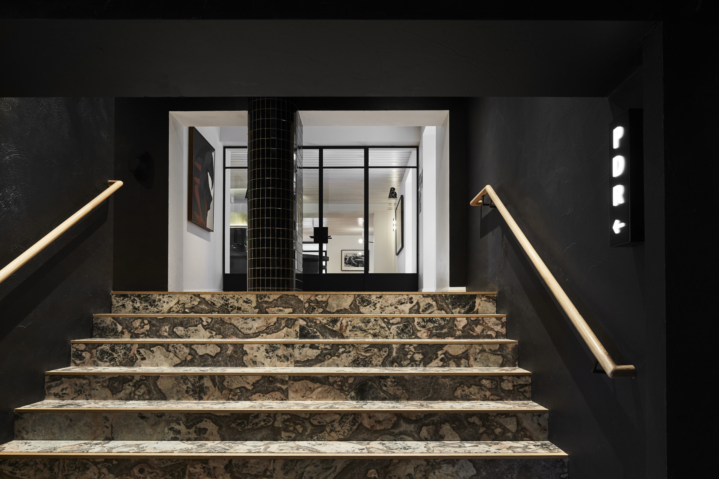 Entrance with marble stairs leading to the Prince Dining Room, featuring sleek modern design.