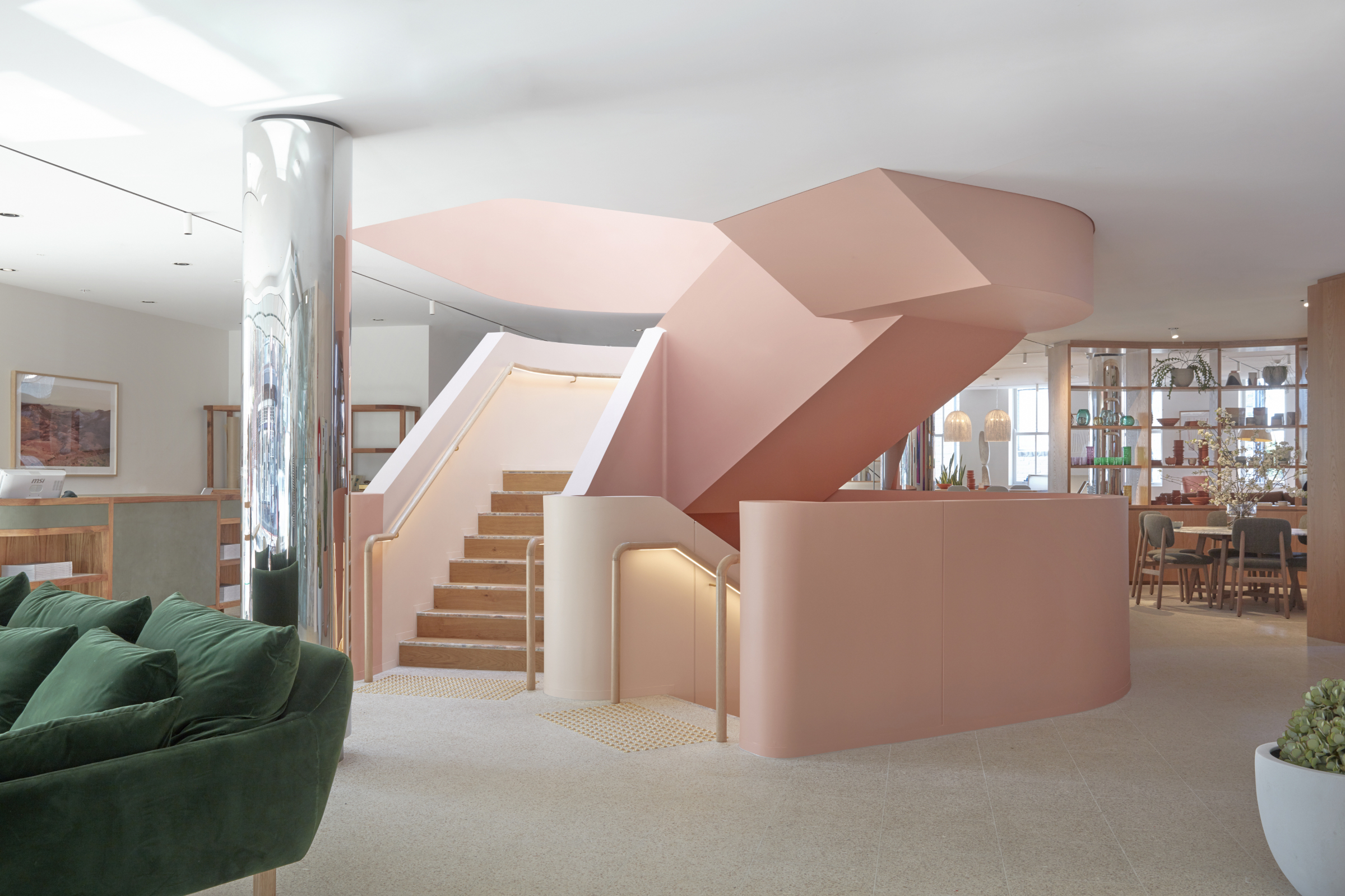 Modern interior with pink staircase and green sofa in Jardan Sydney design.