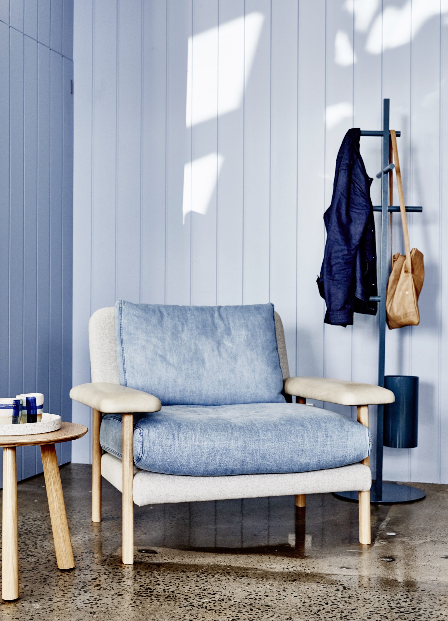 Blue chair and coat rack in a modern room from Jardan Brisbane.