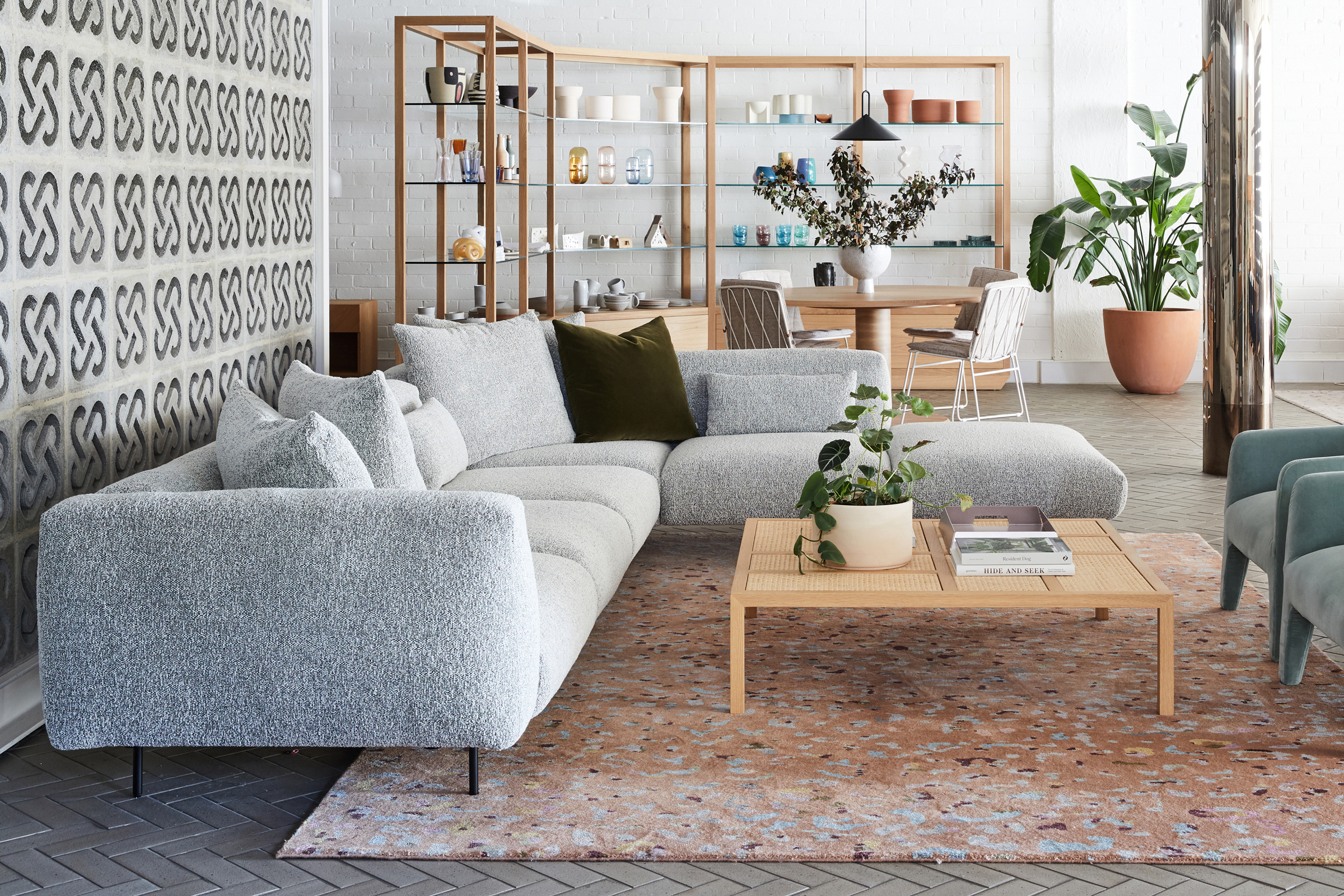 Modern living room design with grey sofa and plants in "Jardan, Melbourne" interior.