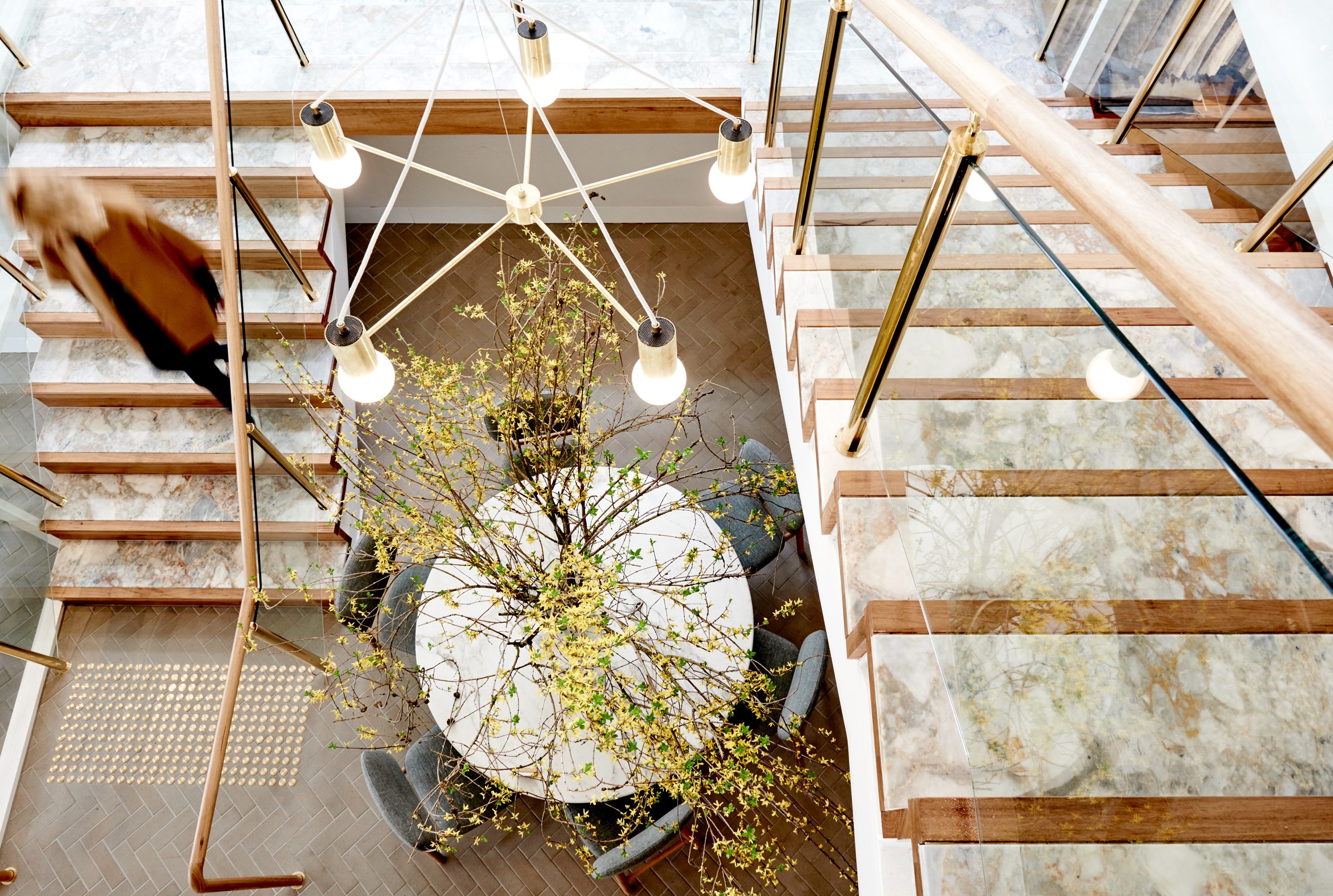 Modern staircase and chandelier design in Jardan, Melbourne, viewed from above.