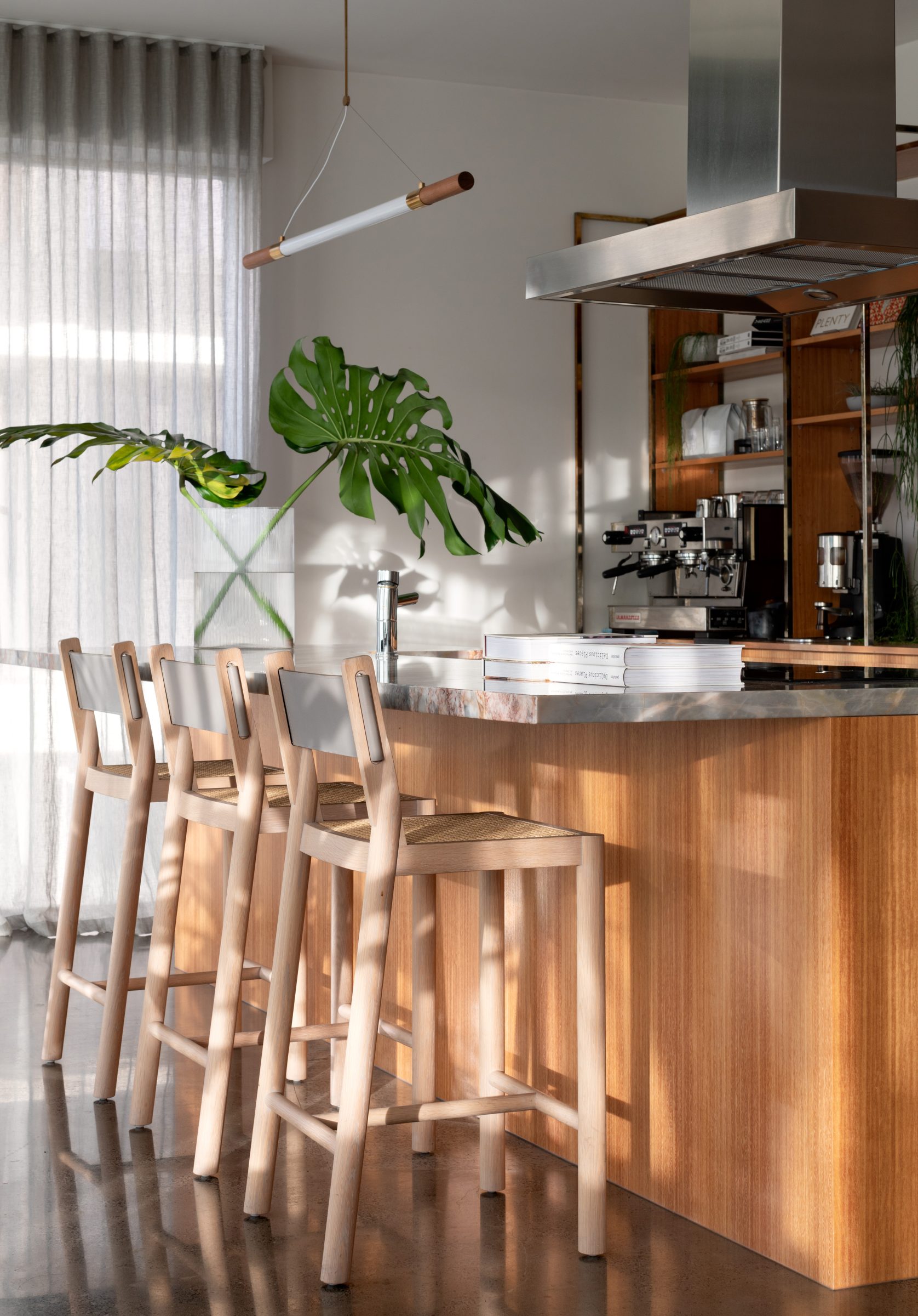 Modern kitchen interior with wooden stools and plants from "Jardan, Melbourne".