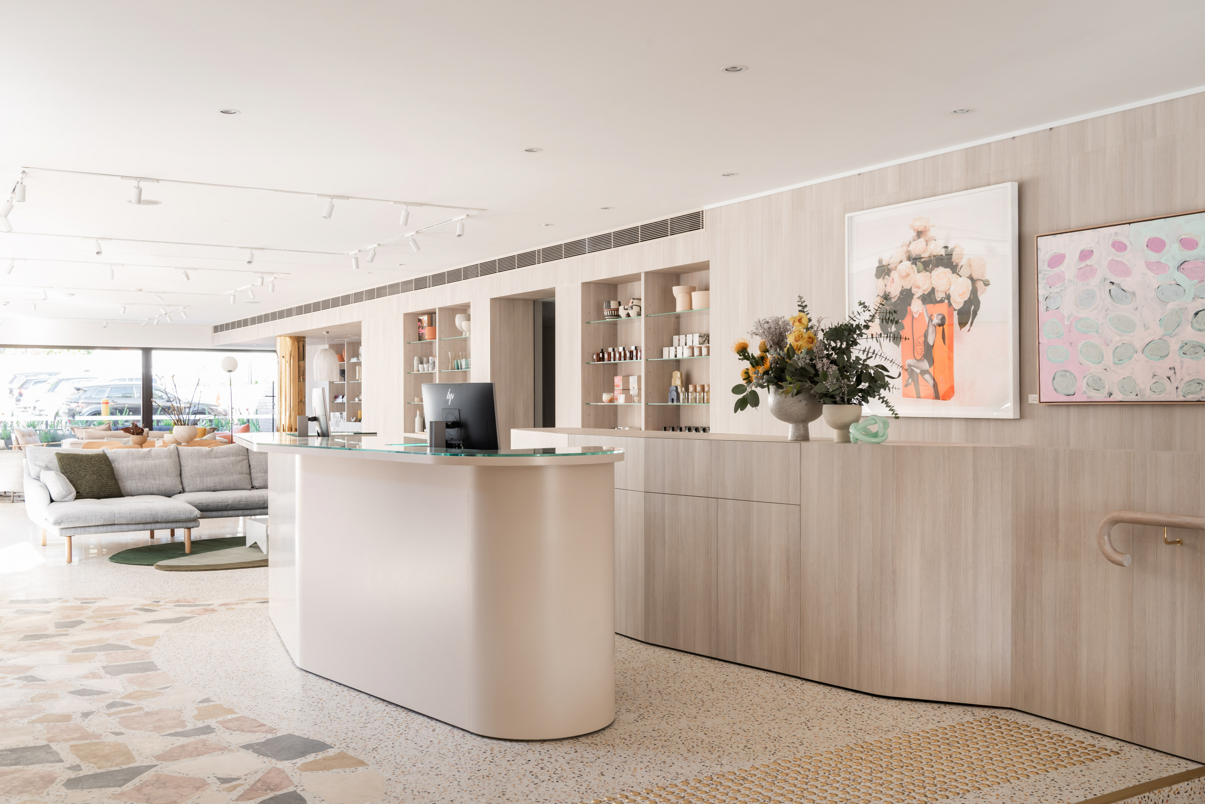 Modern interior design with a reception desk and art display in the Jardan project space.