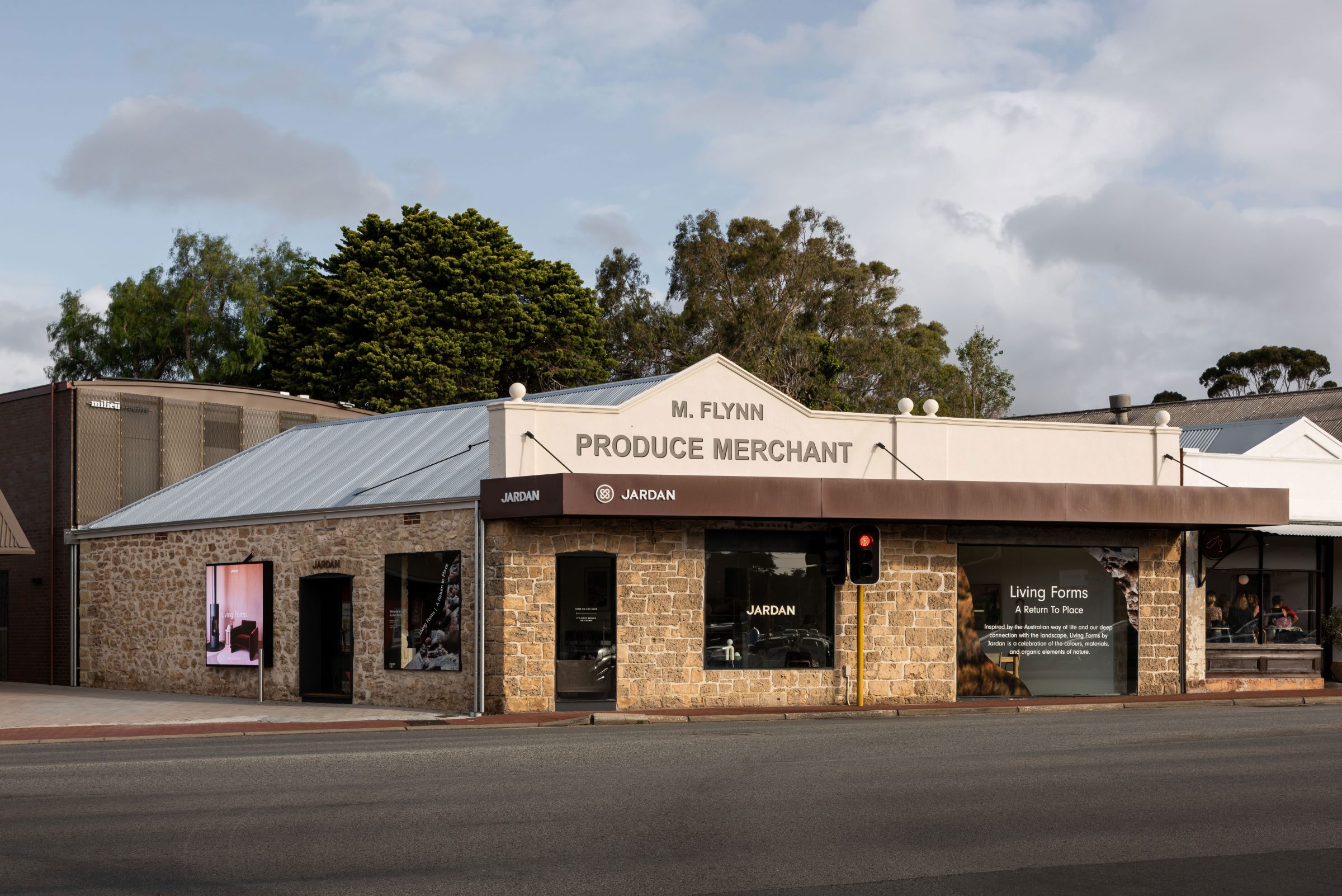 Historic building with Jardan branding and Living Forms display on a sunny street corner.