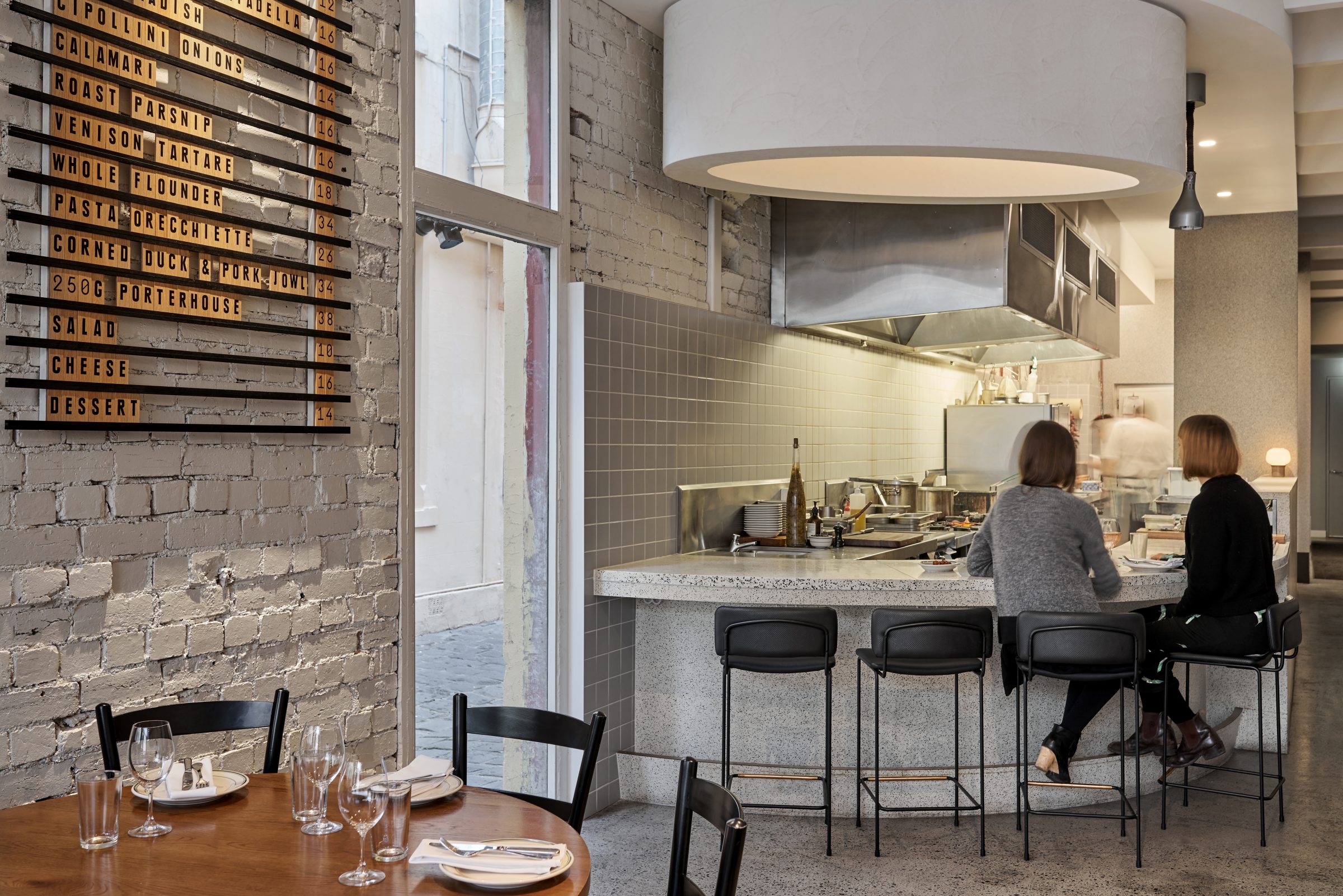 Interior of a stylish restaurant with diners at the counter from the Marion series.