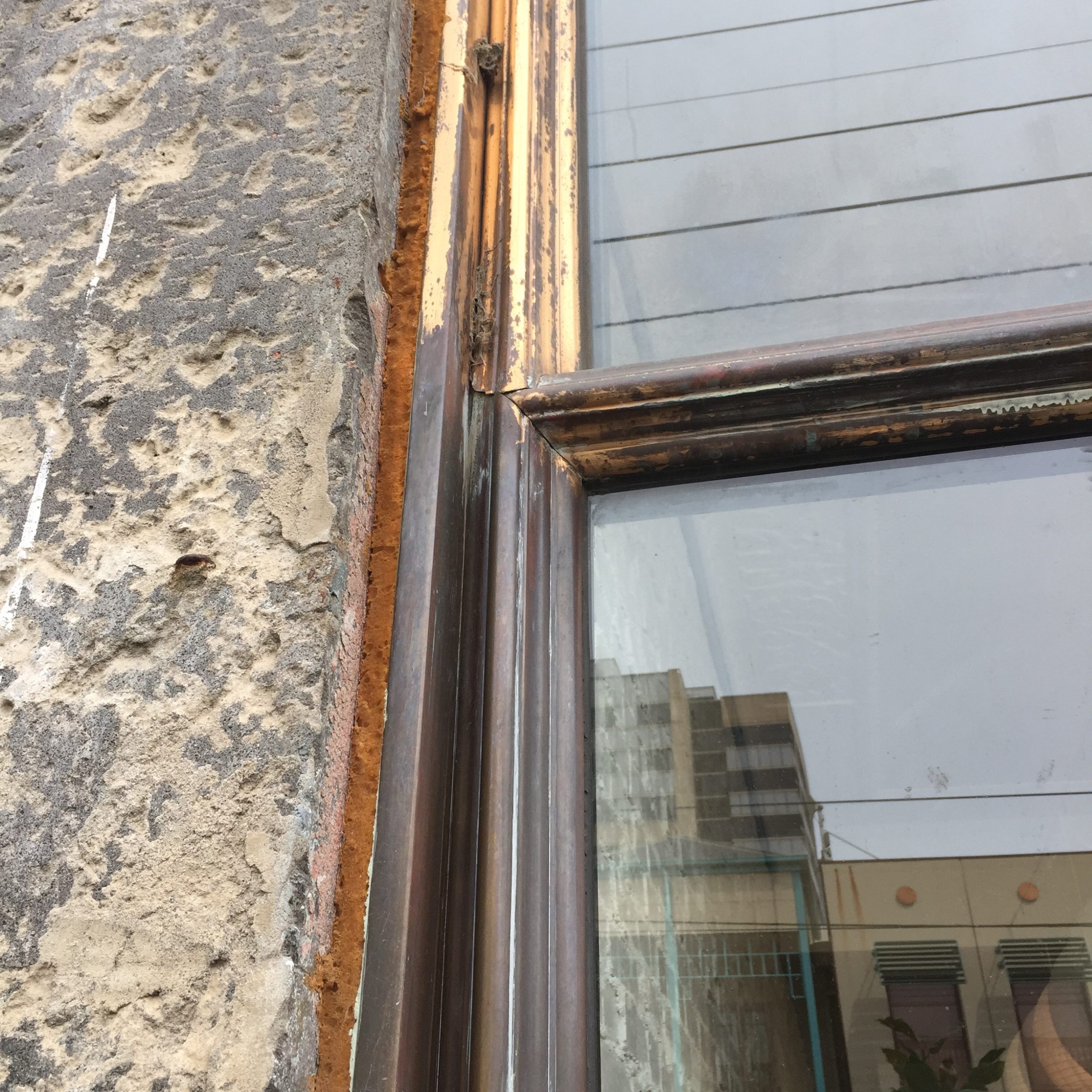 Close-up of a rustic window frame and textured wall from the Marion project.