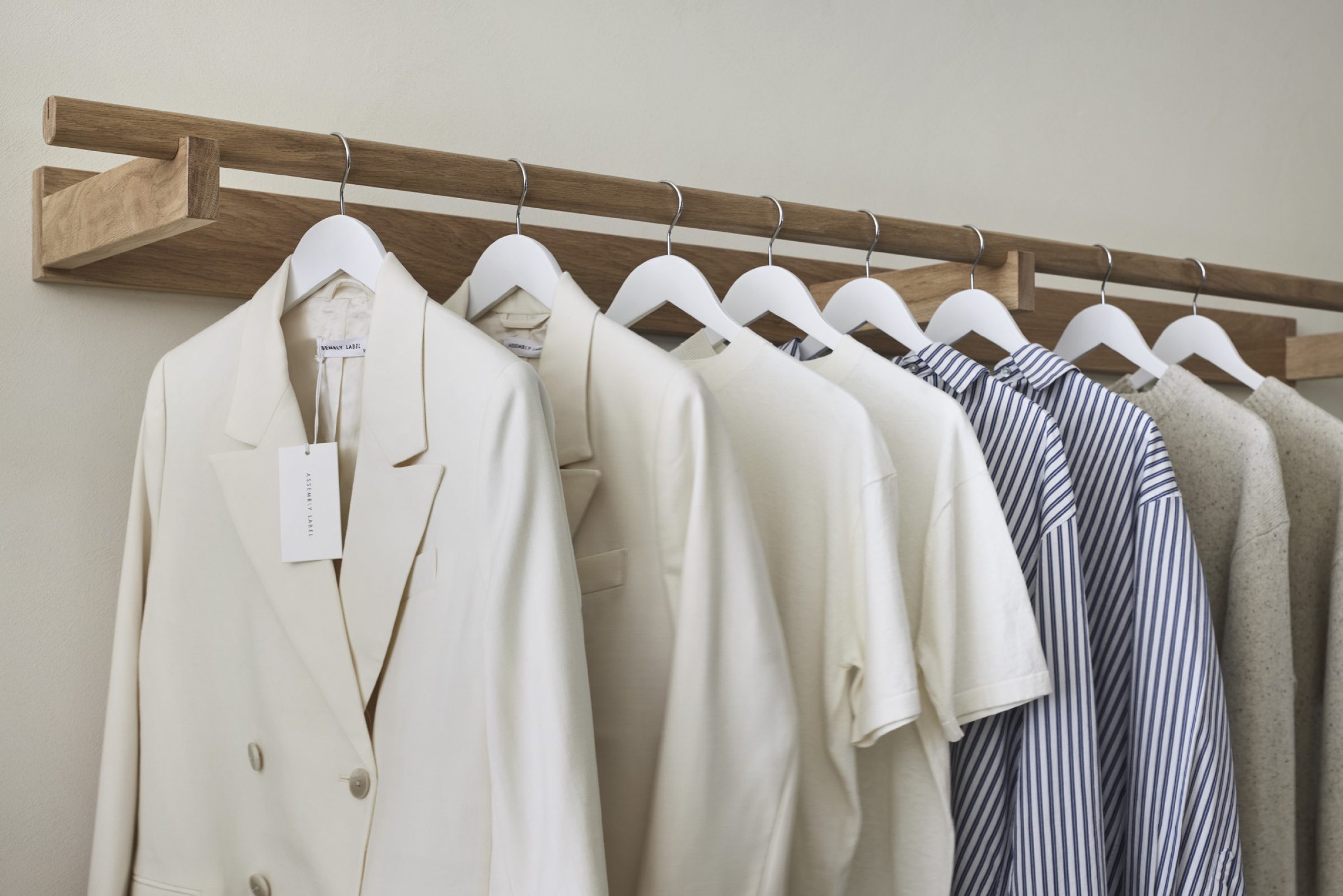 Minimalist clothing on wooden rack from Assembly Label, Adelaide collection.