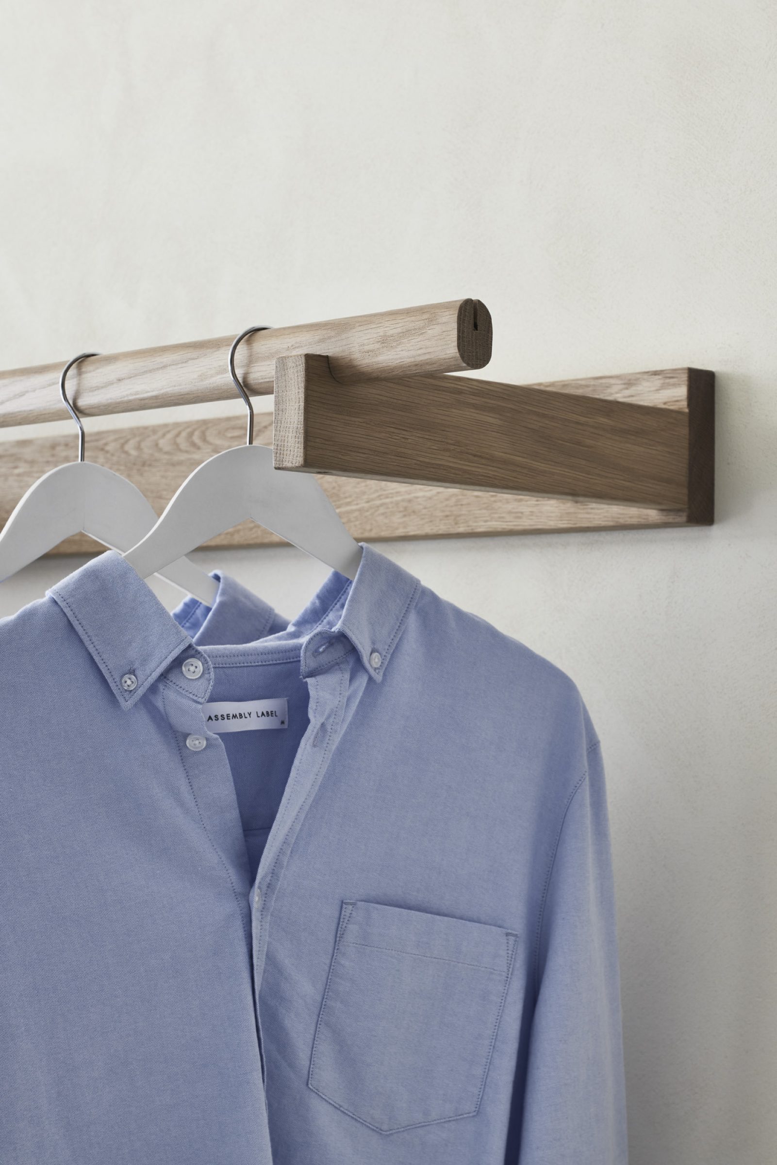 Blue shirt on wooden hanger from Assembly Label, Adelaide collection.