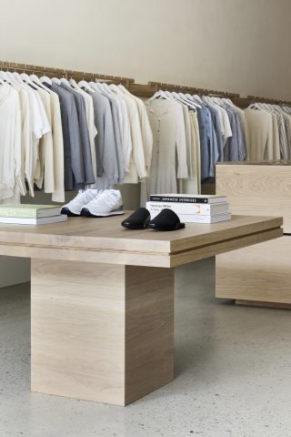 Modern retail display at Assembly Label, Adelaide, featuring neutral clothing and minimalist decor.