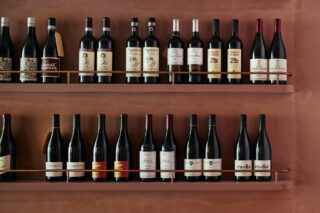 Wine bottles neatly displayed on shelves, part of the Auterra collection.