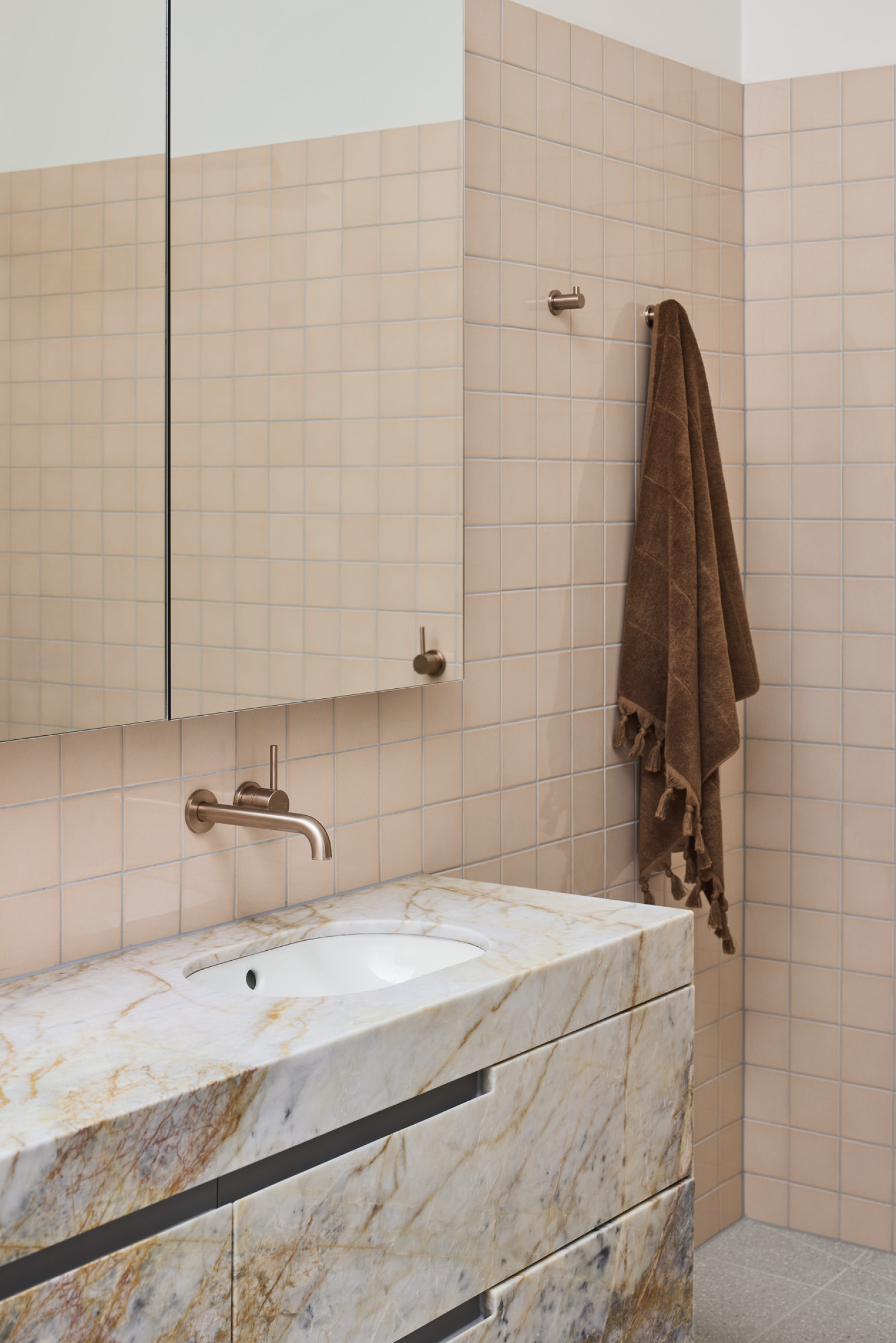Modern bathroom design with marble sink and beige tiles from Day House.