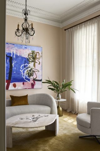 Elegant living room interior from Day House with abstract art and modern furniture.