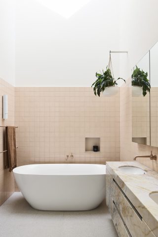 Modern bathroom with freestanding tub and plants, part of Day House.