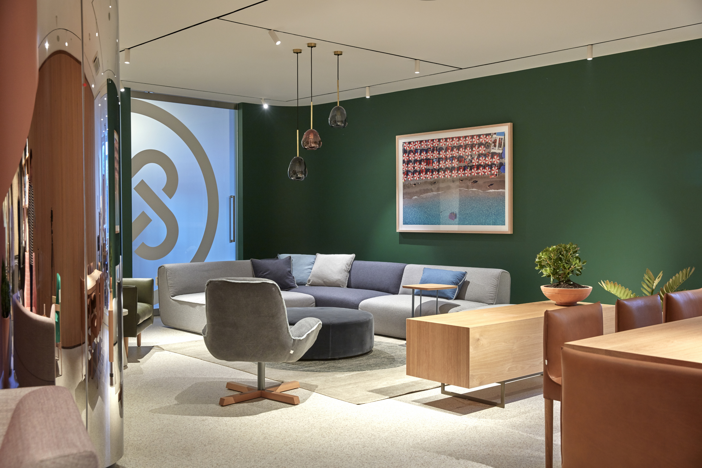 Modern living room design in Jardan Sydney featuring green walls and contemporary furniture.