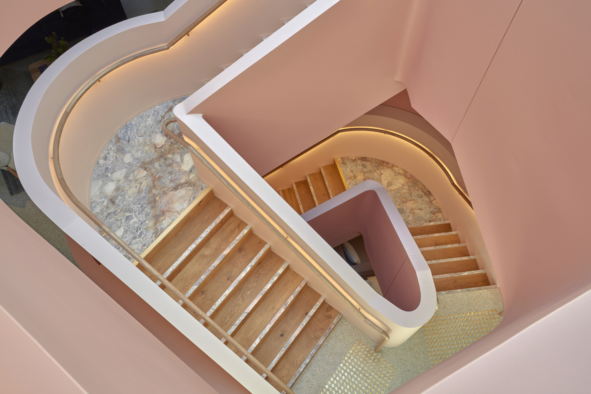 Spiral staircase with pink walls in Jardan Sydney interior design.