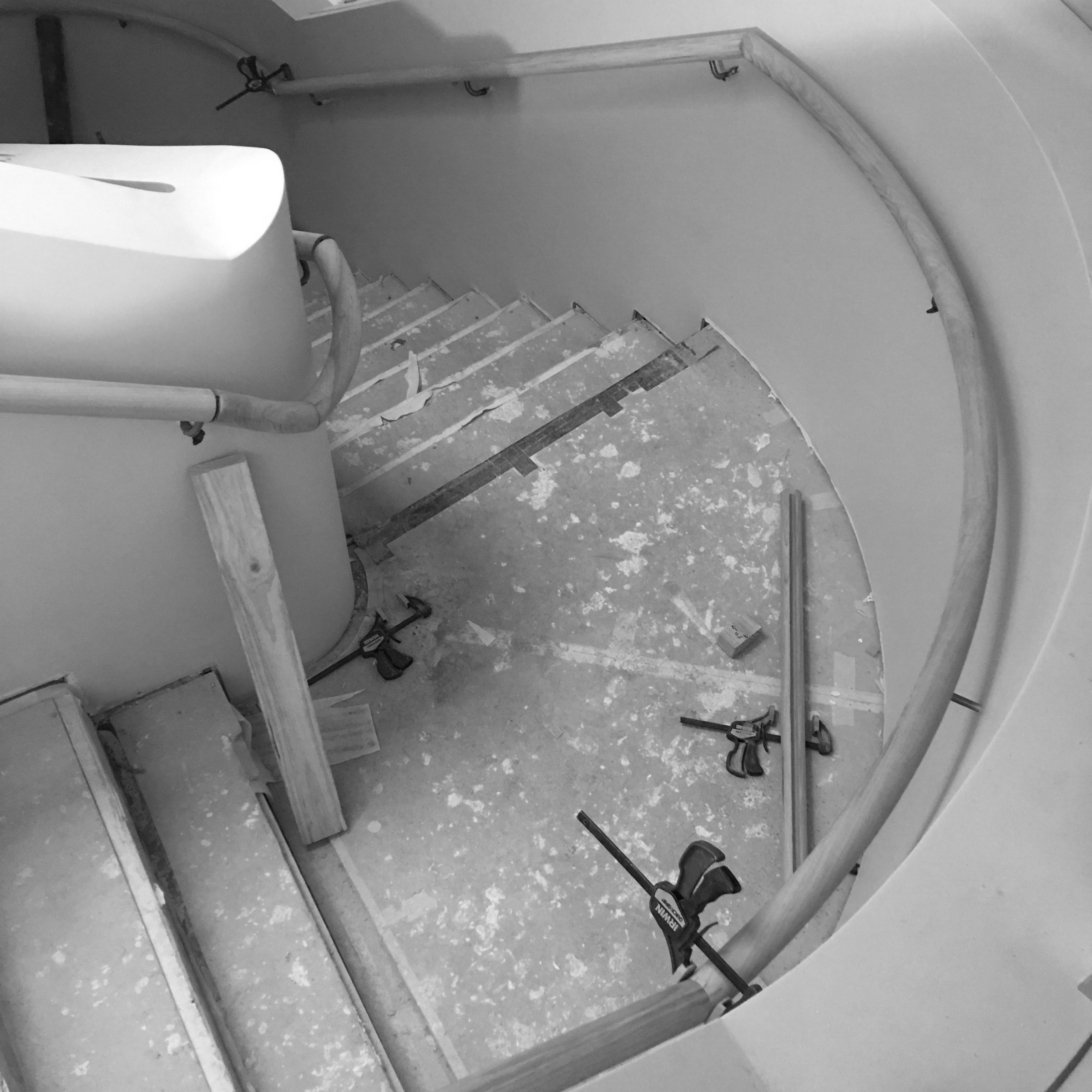 Curved staircase construction in progress at Jardan Sydney with visible tools and materials.