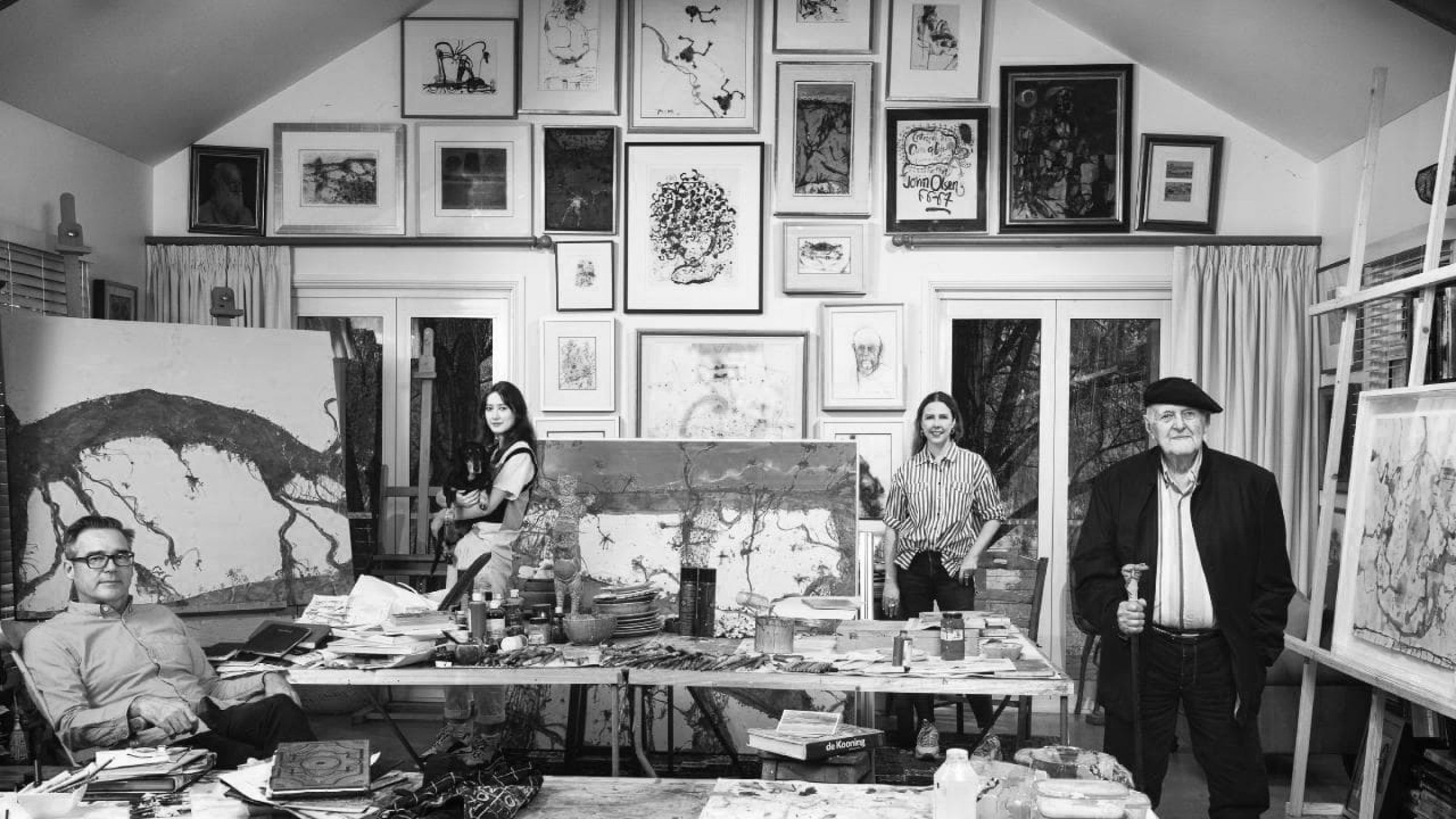 Artists in a studio surrounded by paintings and art supplies for Jardan Sydney.