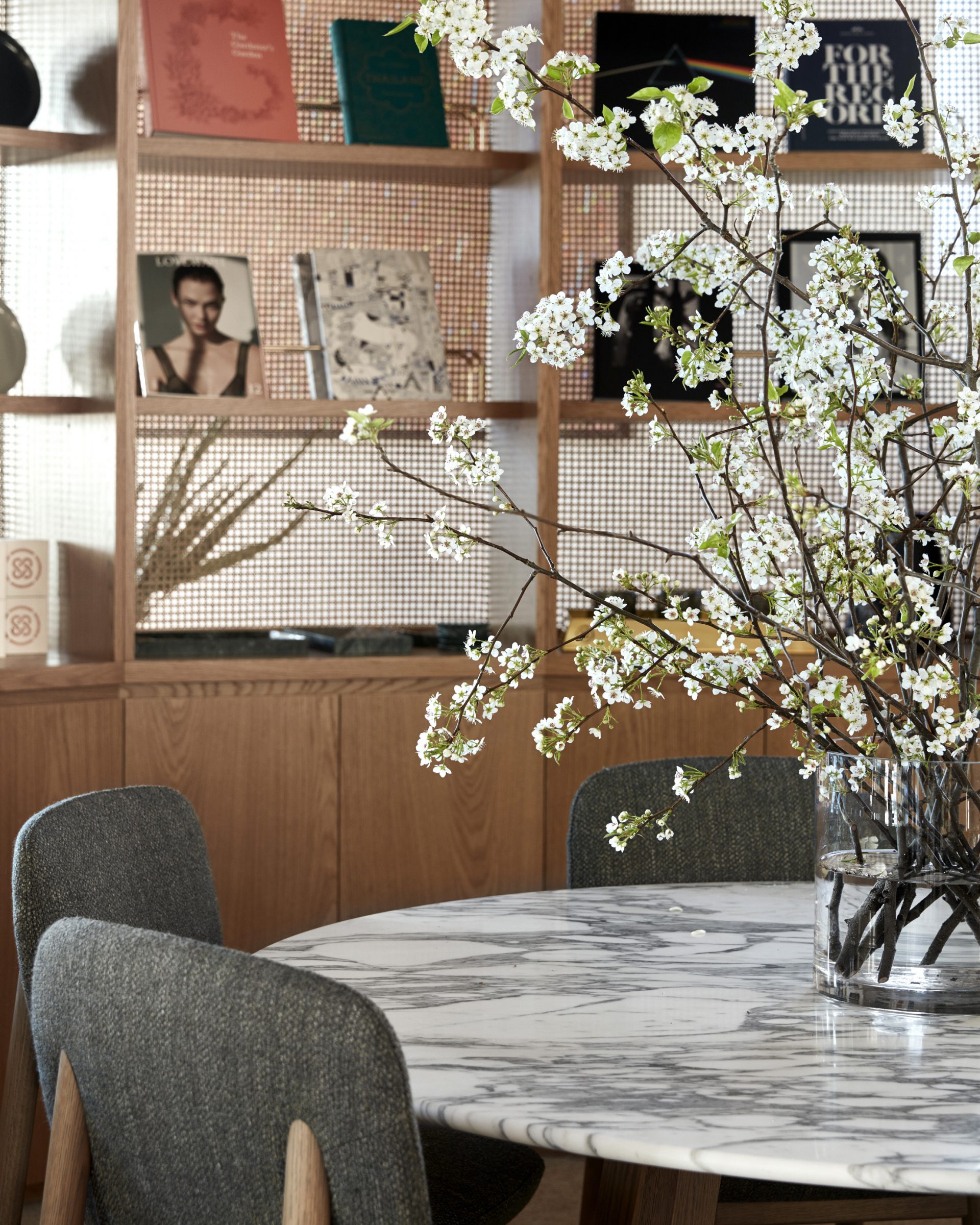 Modern interior scene from Jardan Sydney featuring a marble table and decorative bookshelf.