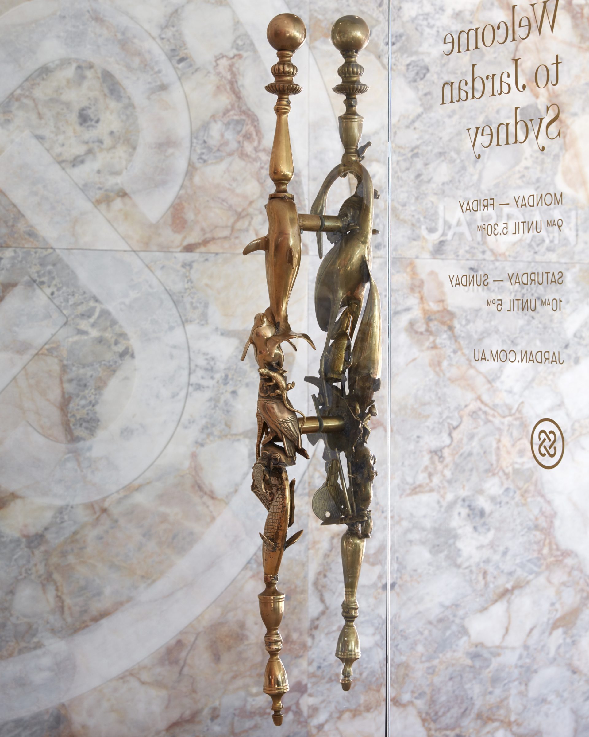 Ornate door handles with animal designs at Jardan Sydney showroom entrance.
