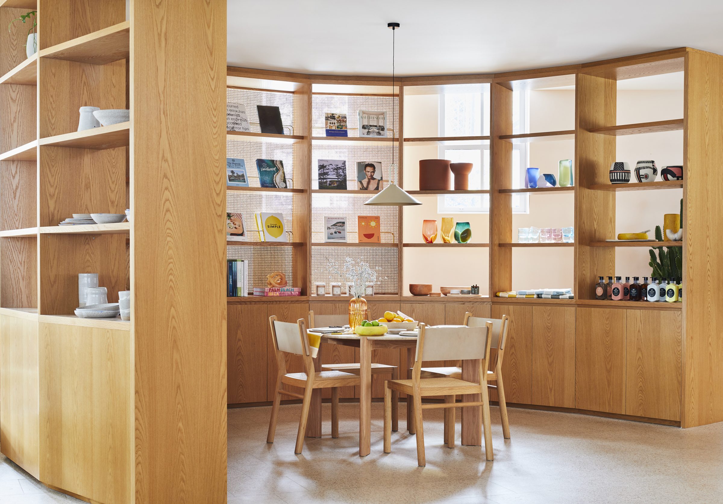 Modern wooden dining area with open shelving, part of the Jardan, Sydney project.
