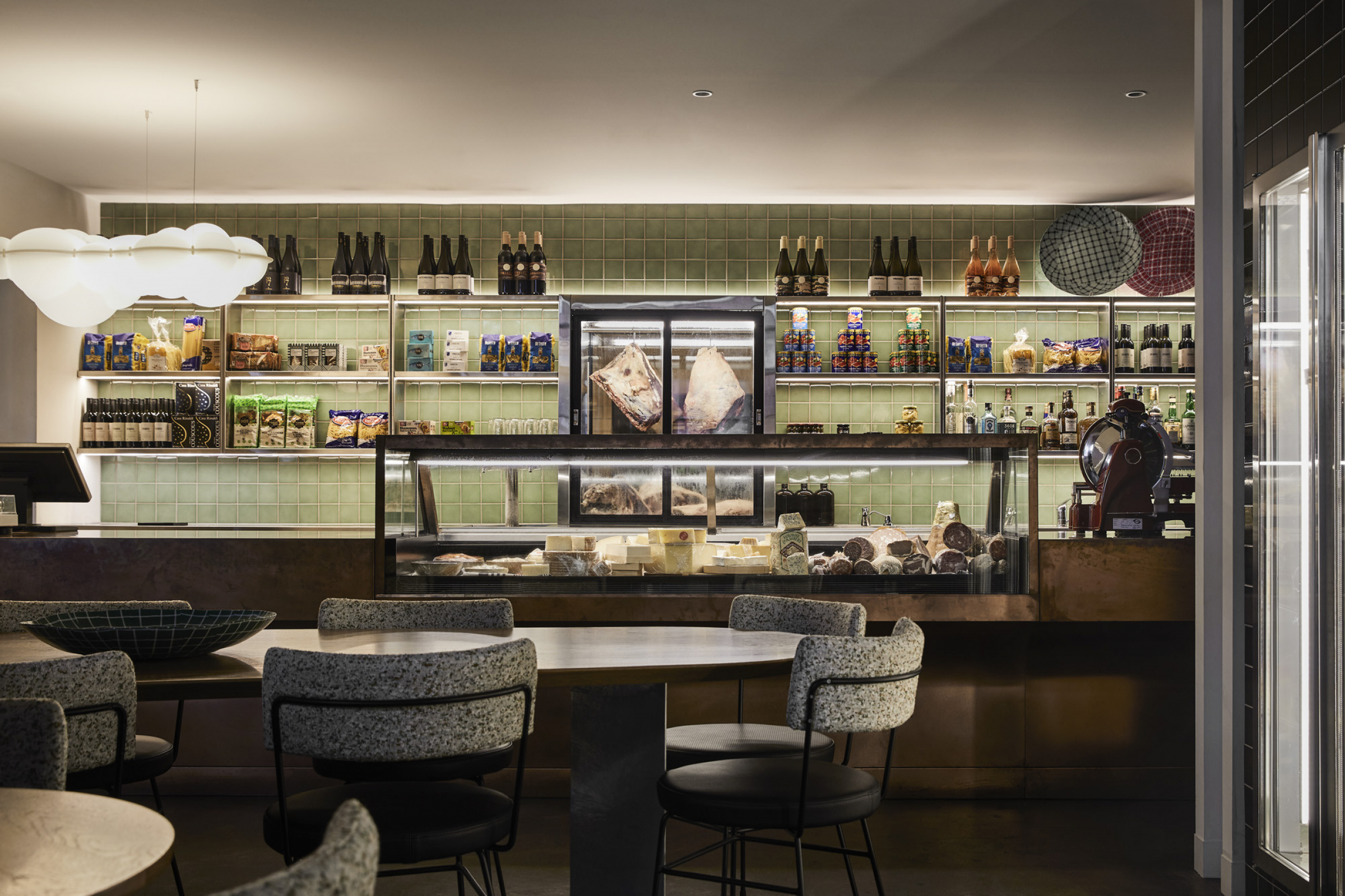 Modern deli interior with wines and cheeses from Little Prince Wine displayed on shelves and counters.