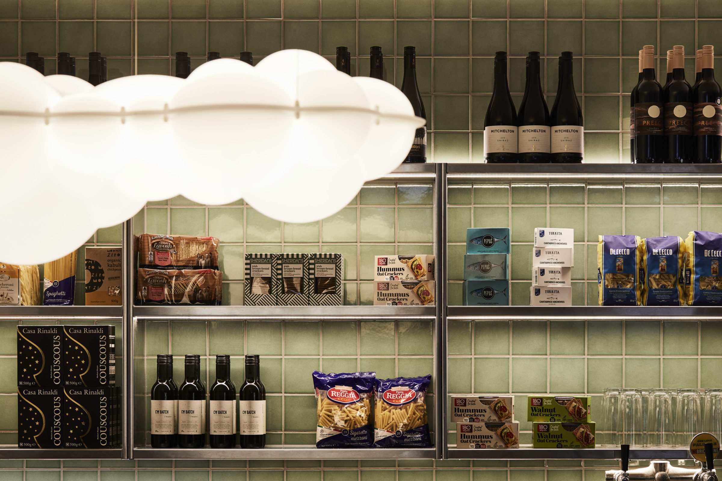 Store shelves with wine bottles and food products for Little Prince Wine.