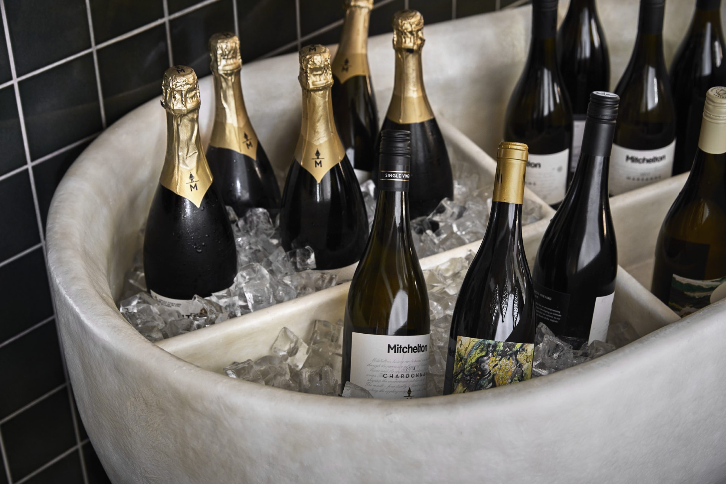 Bottles of wine and champagne chilled in ice for Little Prince Wine collection.
