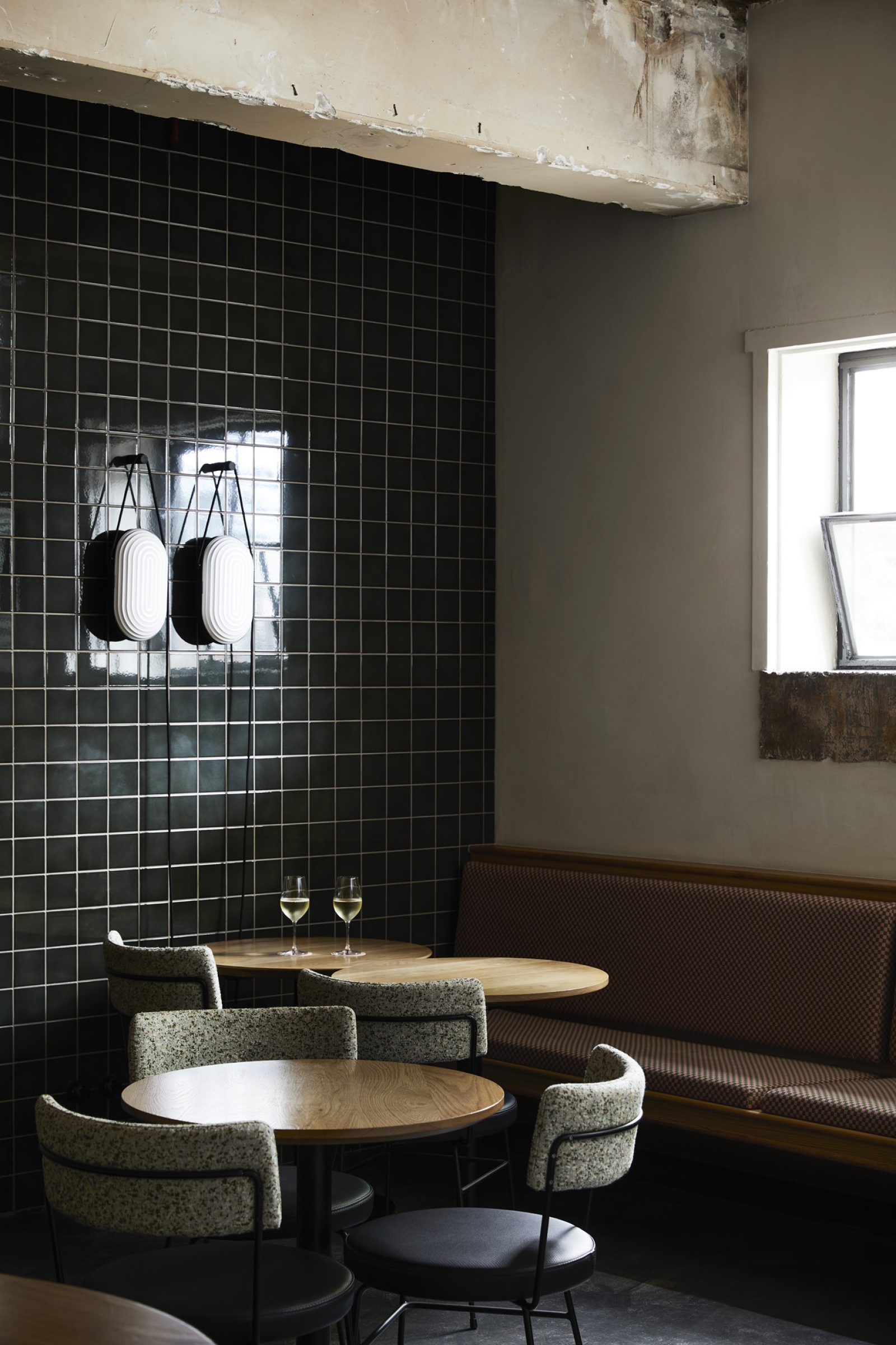 Cozy wine bar interior with two glasses of wine on a table Little Prince Wine.