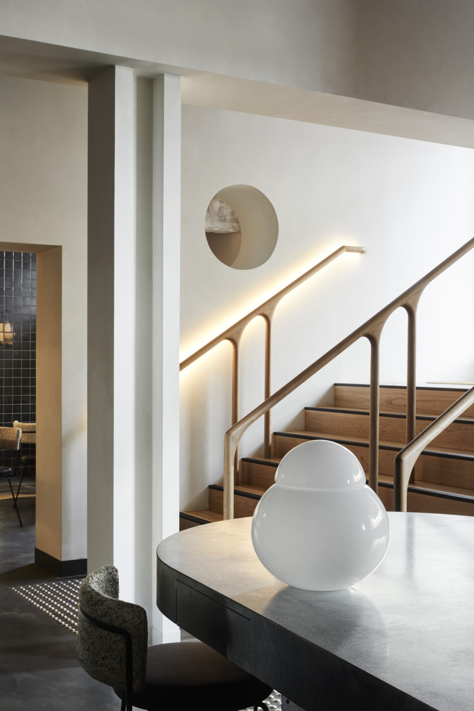 Modern interior design featuring sleek staircase and table from Little Prince Wine.