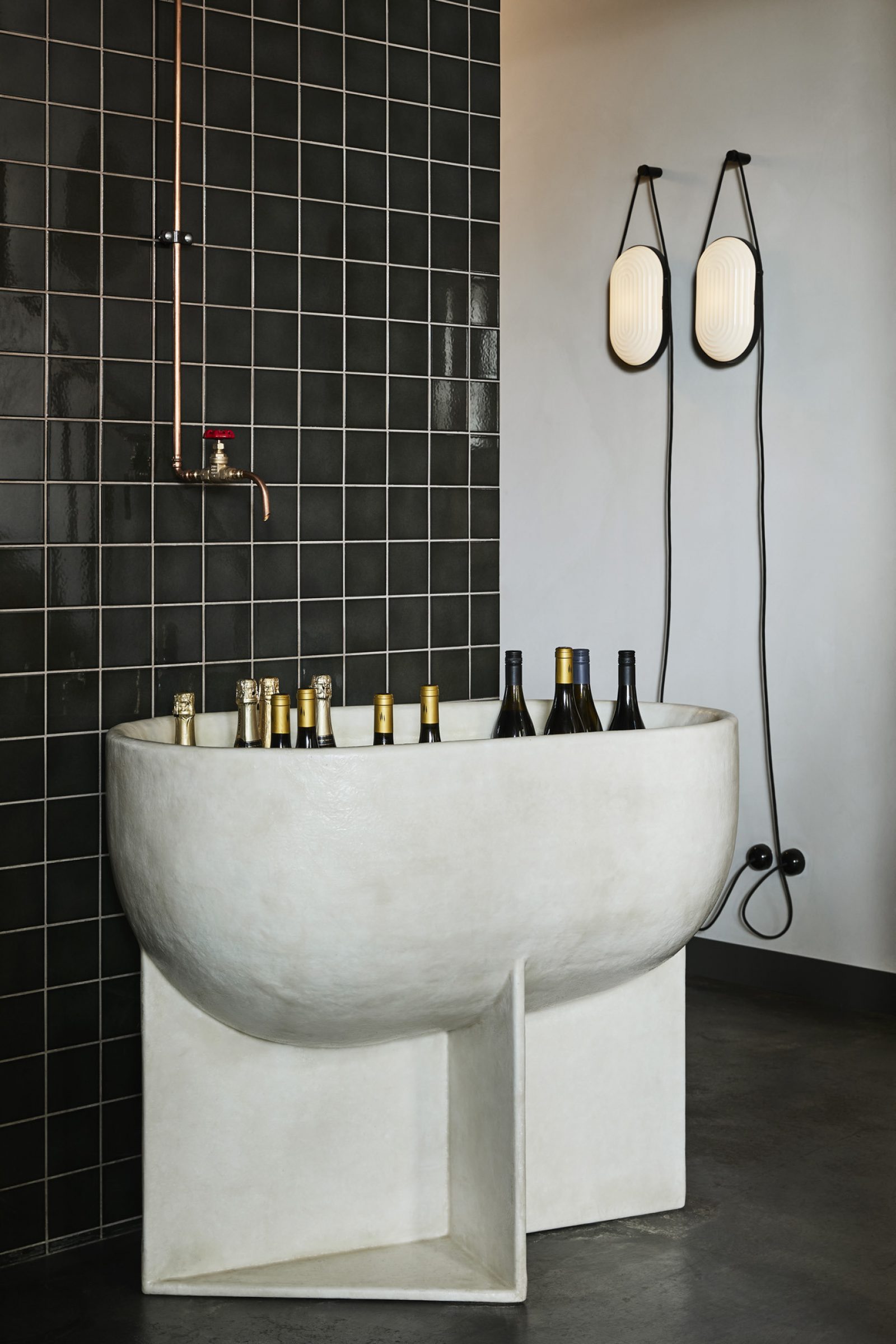 Little Prince Wine display with bottles in a unique modern stone basin.