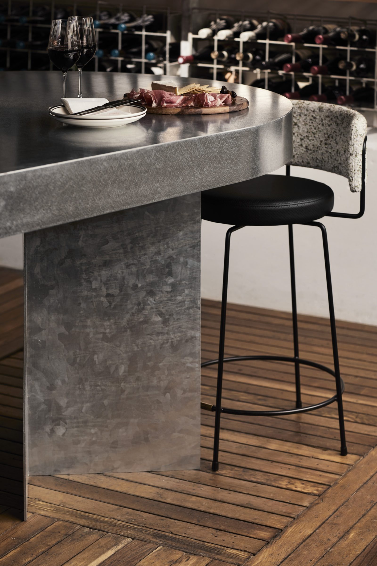 Little Prince Wine setting with glasses, charcuterie, and a modern bar stool.