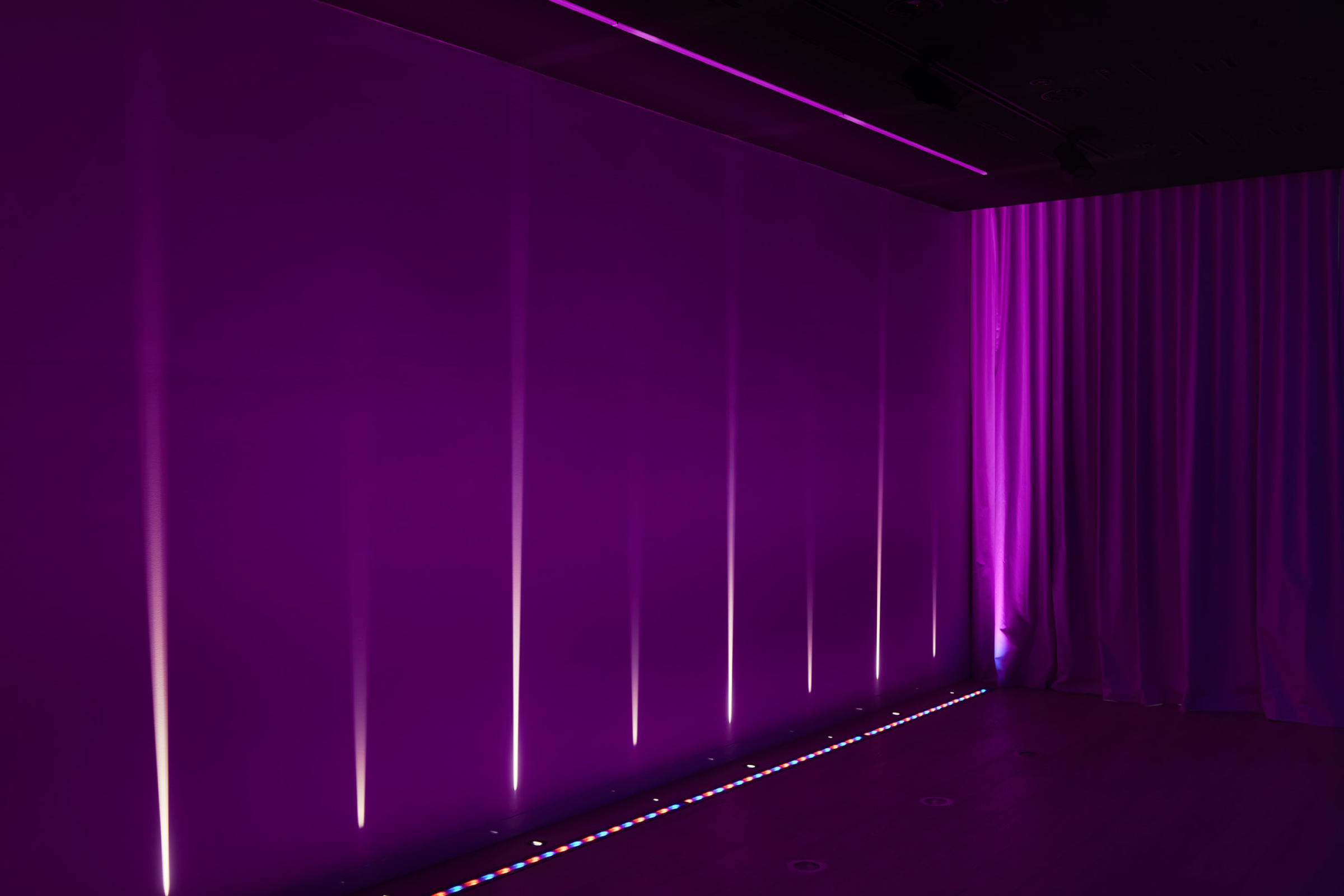 Lux-Fx installation featuring vibrant purple lighting and sleek, modern design elements.