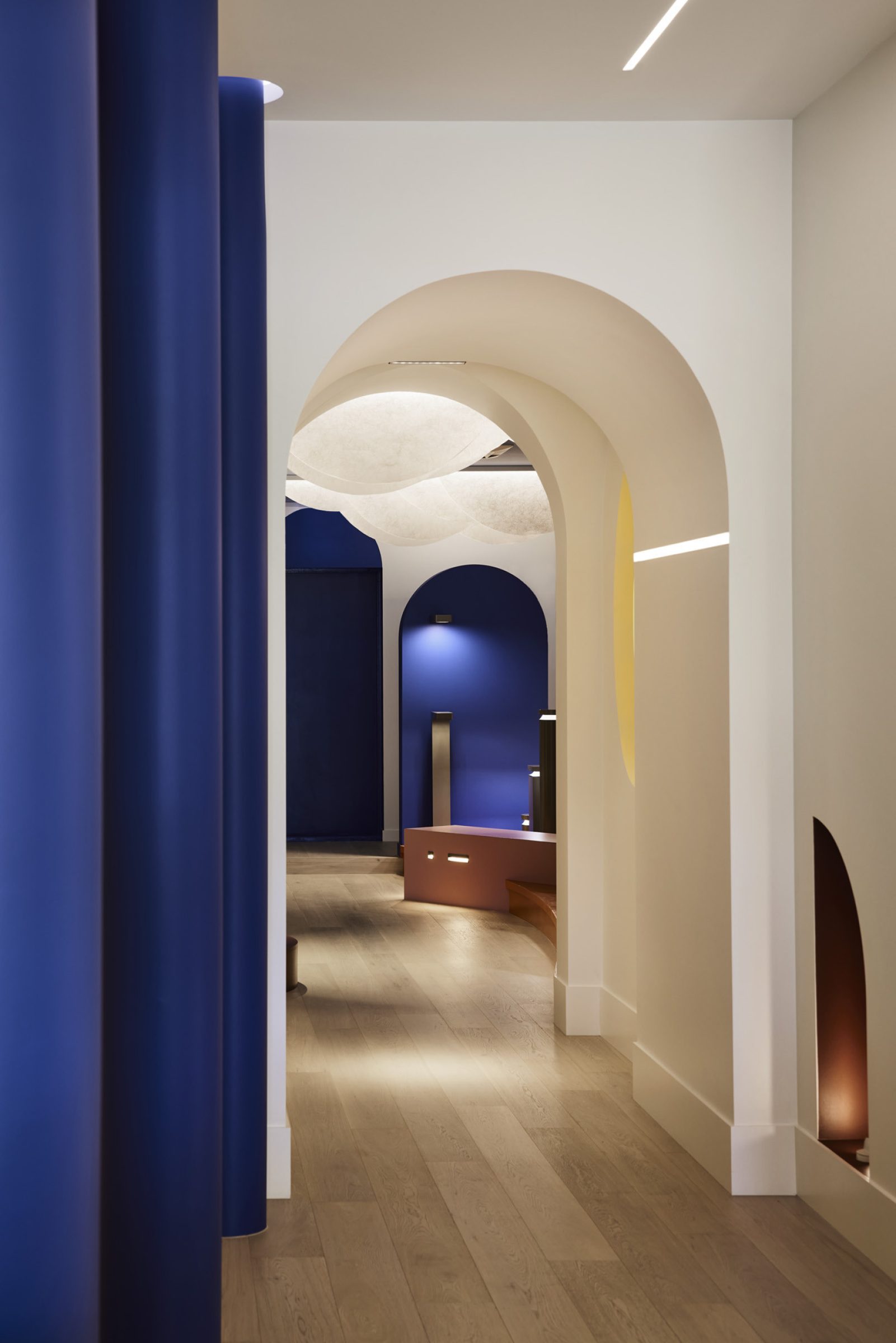 Arched hallway with artistic lighting and blue accents, part of Lux-Fx.
