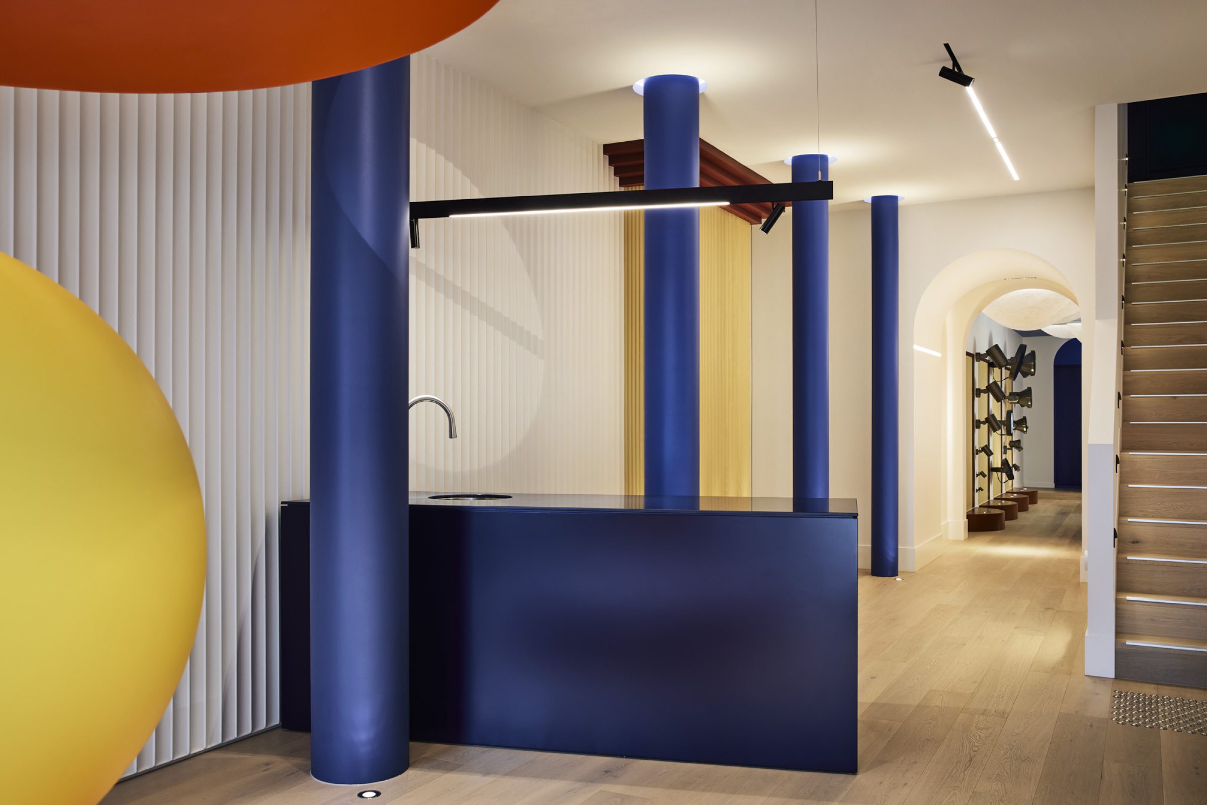 Lux-Fx modern interior with colorful columns, sleek lighting, and minimalist design elements.