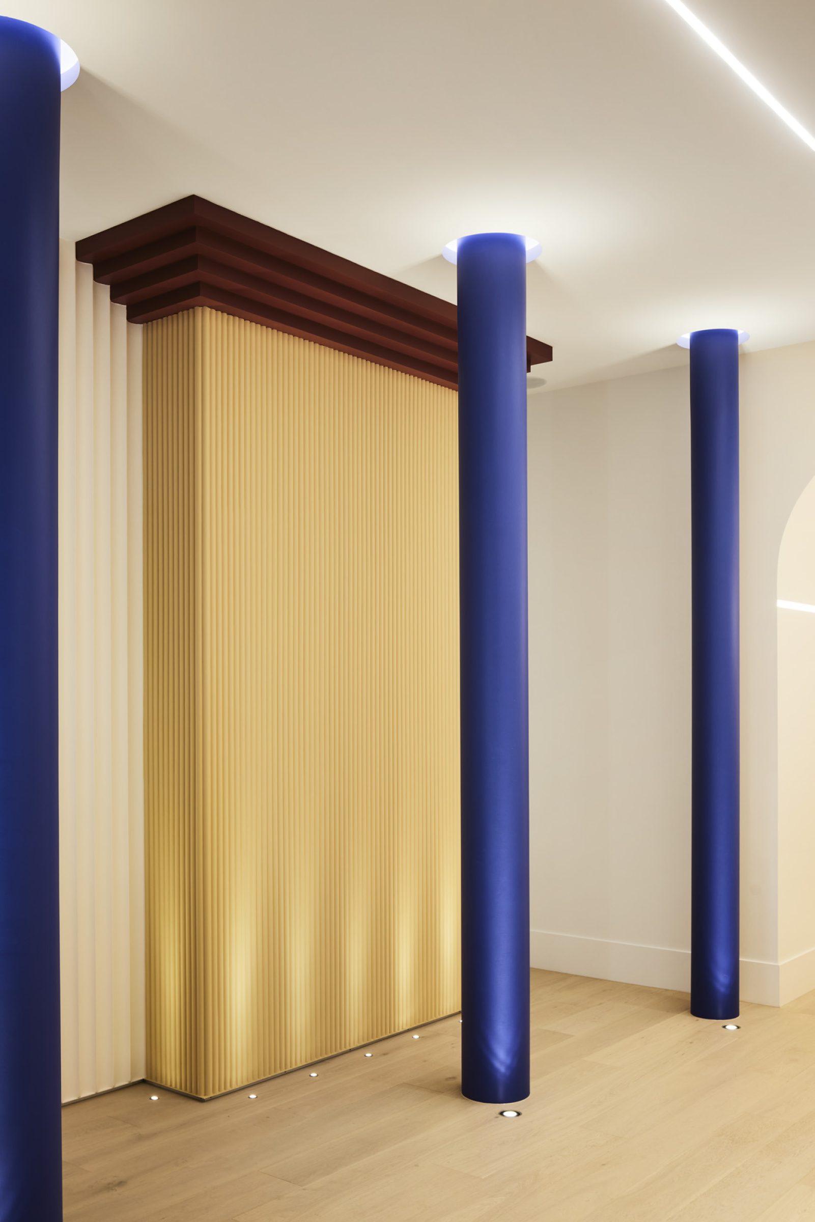 Lux-Fx features a modern interior with blue pillars and textured golden walls.