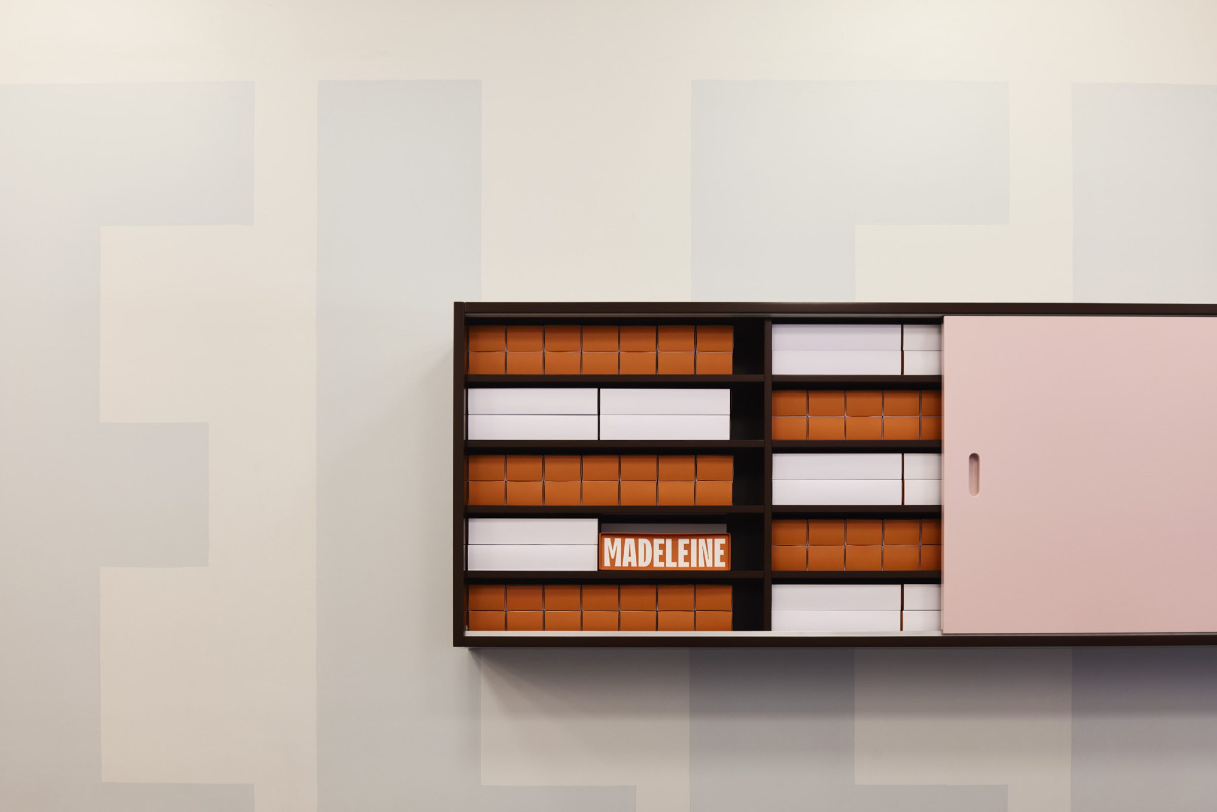 Shelf with organized boxes and a "Madeleine" sign from the Madeleine de Proust collection.