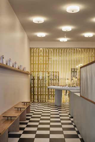 Interior of a stylish patisserie with checkerboard floor from "Madeleine de Proust".