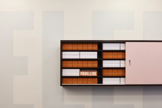 Shelf with organized boxes and a "Madeleine" sign from the Madeleine de Proust collection.