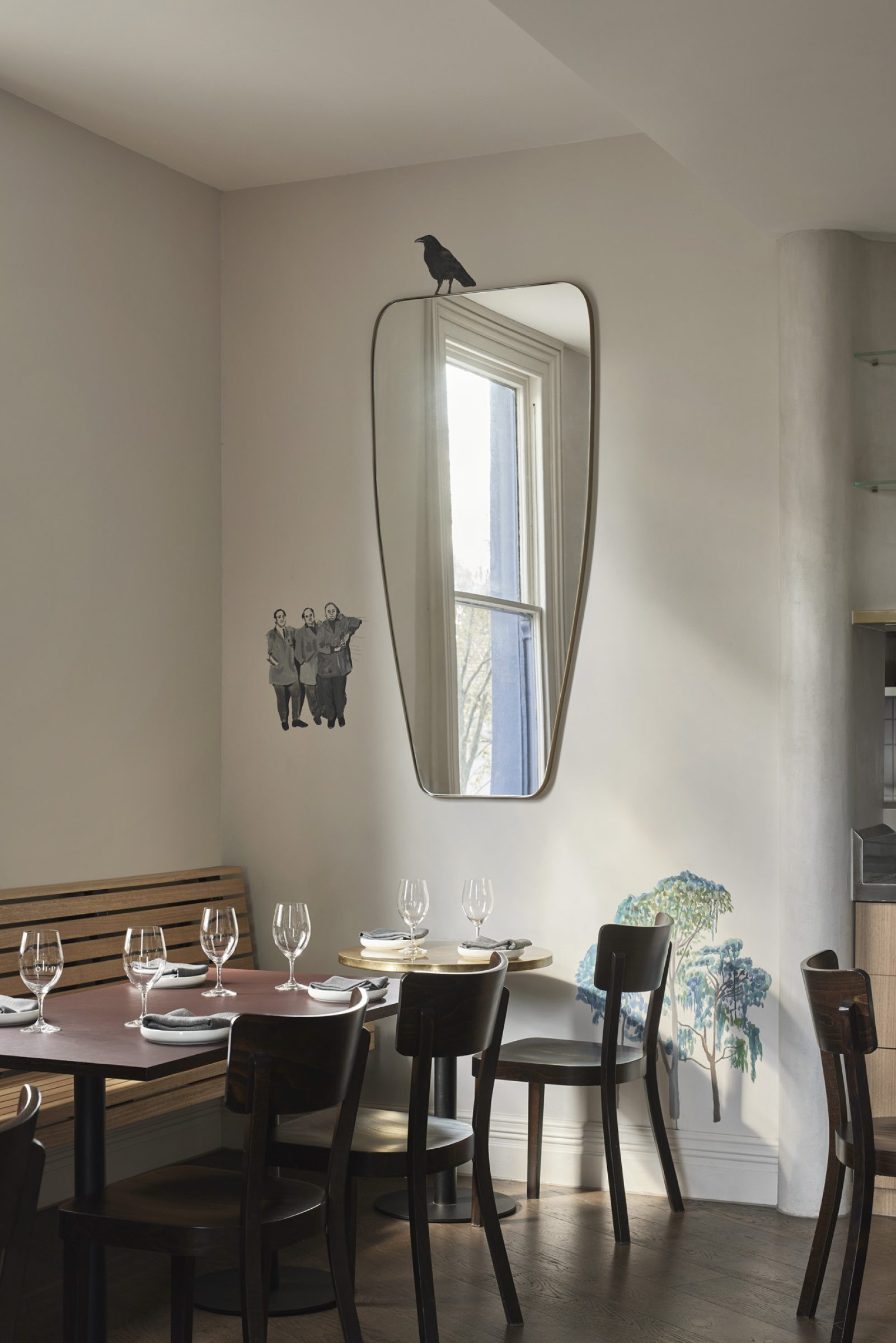 Dining area with wall art and mirror from "One Trick Pony".