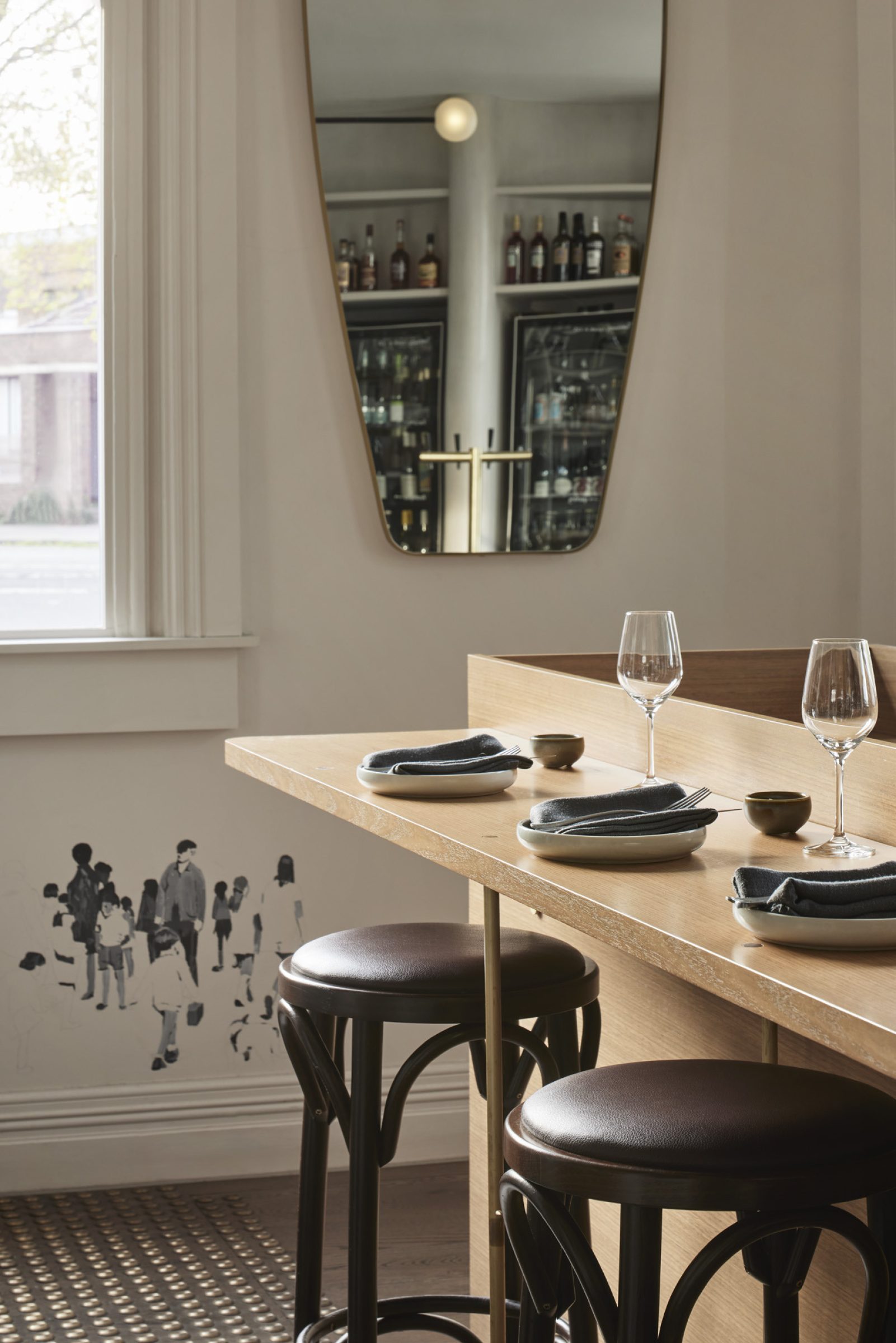 Elegant dining setup with abstract wall art in "One Trick Pony".