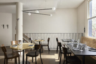 Modern restaurant interior with elegant table settings, part of "One Trick Pony" series.