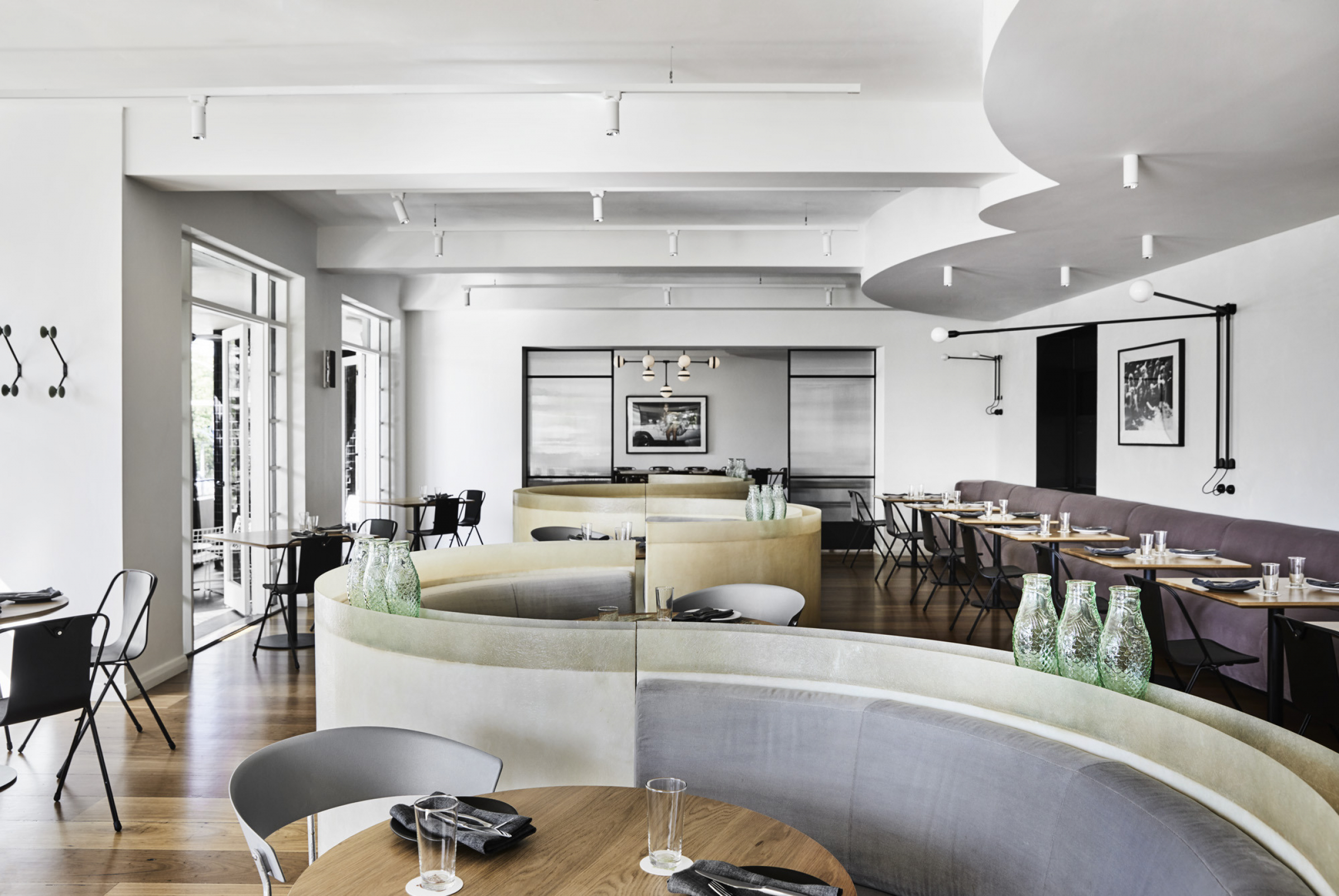 Modern dining room with curved seating and elegant decor from Prince Dining Room project.
