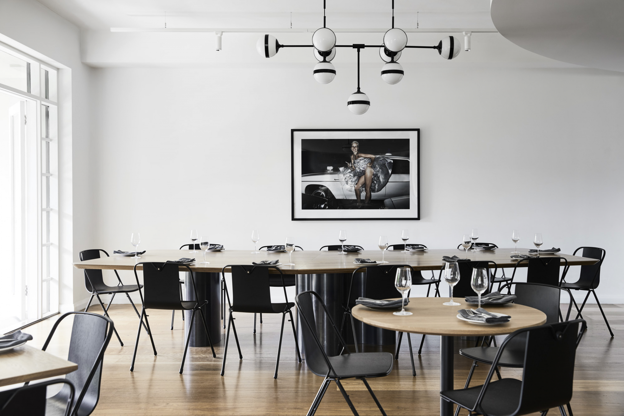 Modern dining room setup with black chairs and round tables in Prince Dining Room.